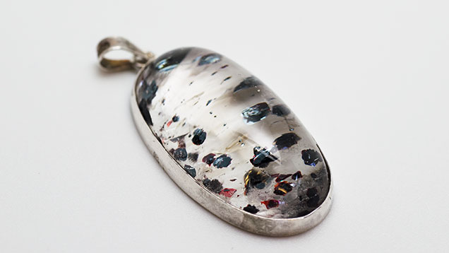 Quartz silver pendant with hematite inclusions. Quartz silver pendant with hematite inclusions.